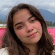 Portrait of actress Genea Charpentier smiling confidently, showcasing her youthful charm and rising presence in film and television.