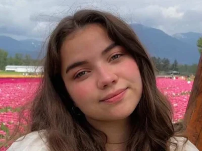 Portrait of actress Genea Charpentier smiling confidently, showcasing her youthful charm and rising presence in film and television.
