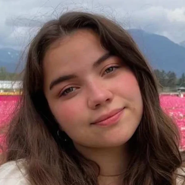 Portrait of actress Genea Charpentier smiling confidently, showcasing her youthful charm and rising presence in film and television.