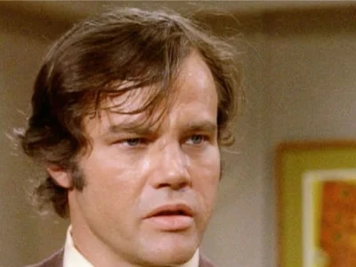 Joe Don Baker Net Worth-vintage photo of the actor in a classic film setting, reflecting his successful Hollywood career.
