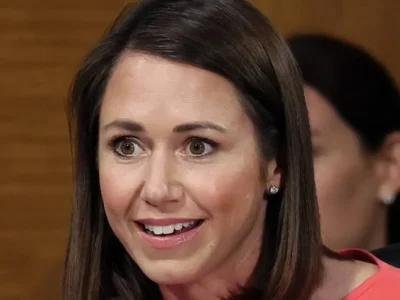 Katie Britt smiling in professional attire during Senate committee hearing - Alabama Senator with $4.5 million net worth
