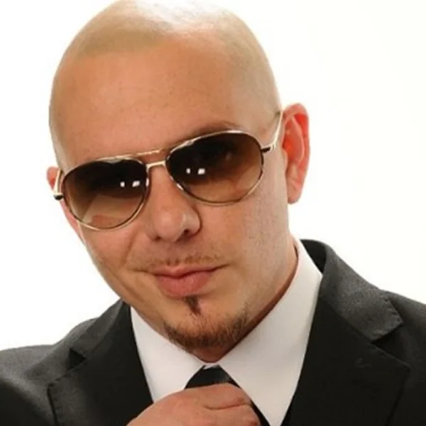 "Pitbull Net Worth 2025: Armando Christian Pérez in a sharp suit, smiling confidently with Miami skyline backdrop."