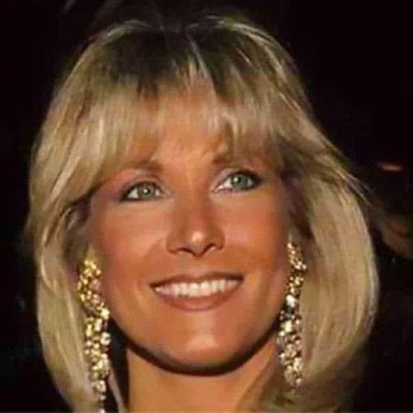 Alexis Maas smiling at a formal event, showcasing her elegant style and grace, reflecting her intriguing life story.