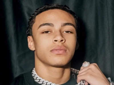 DD Osama wearing diamond chain showing his net worth success as young rapper