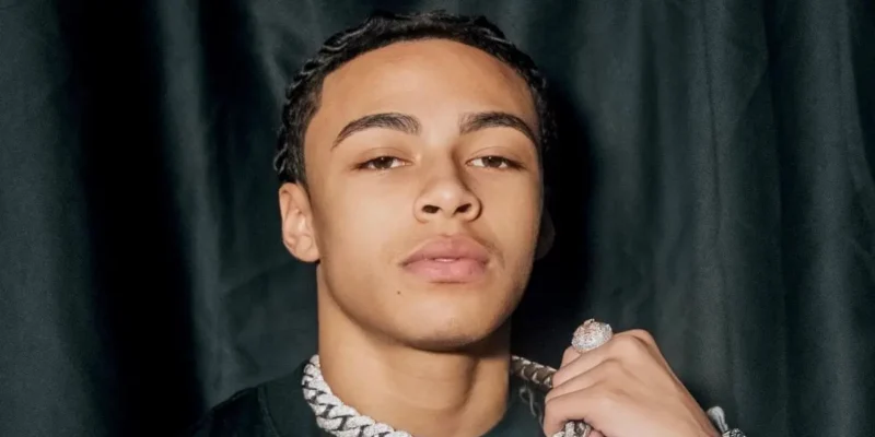 DD Osama wearing diamond chain showing his net worth success as young rapper
