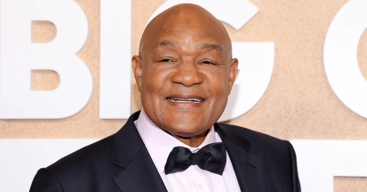 George Foreman smiling at a public event, representing his success story in boxing and business featured in our article on George Foreman.