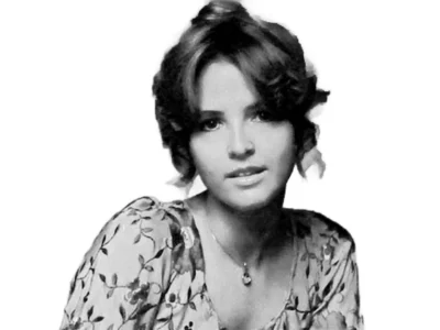 LaCosta Tucker in a vintage floral dress, showcasing her classic country style during her early music career.