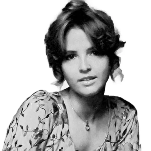 LaCosta Tucker in a vintage floral dress, showcasing her classic country style during her early music career.