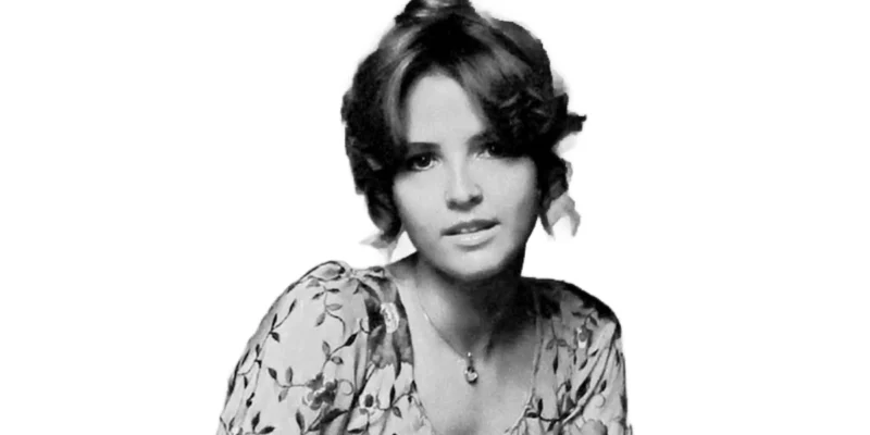 LaCosta Tucker in a vintage floral dress, showcasing her classic country style during her early music career.