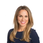 Nicole Saphier speaking at a medical conference, highlighting her role as a breast radiologist and cancer detection expert.