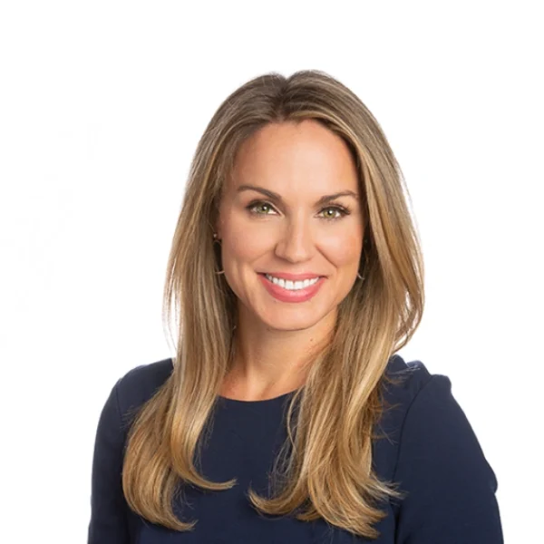 Nicole Saphier speaking at a medical conference, highlighting her role as a breast radiologist and cancer detection expert.