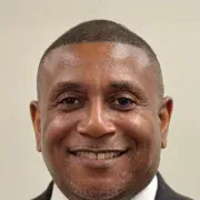 Rodney Tyson professional headshot - corporate executive and education leader smiling in business suit