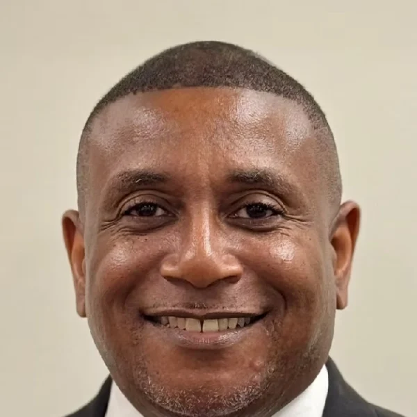 Rodney Tyson professional headshot - corporate executive and education leader smiling in business suit