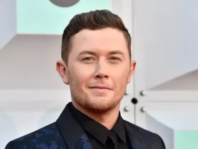 Scott Mccreery Net Worth: Country star Scott McCreery smiling at an awards event, symbolizing his musical success and financial achievements.