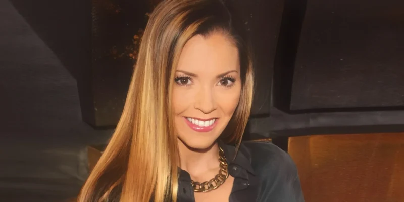 Sydney Bernard confidently posing at a media event, reflecting her dynamic presence and influence in the entertainment industry.