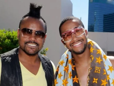 Ukil Grandberry and associate wearing fashionable clothing and sunglasses in professional photo shoot setting.