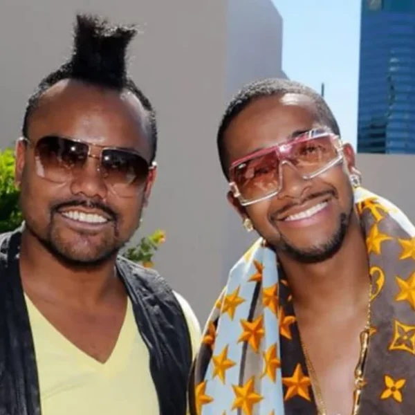 Ukil Grandberry and associate wearing fashionable clothing and sunglasses in professional photo shoot setting.
