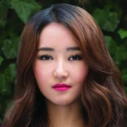 Yeonmi Park Net Worth: Yeonmi Park smiling confidently outdoors, symbolizing her inspiring journey and financial achievements.