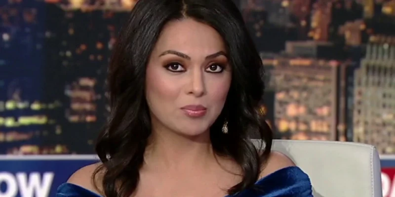 Aisha Hosny on set in a blue dress, confidently presenting live news, reflecting her growing influence in 2025 media.