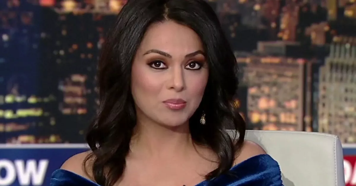 Aisha Hosny on set in a blue dress, confidently presenting live news, reflecting her growing influence in 2025 media.