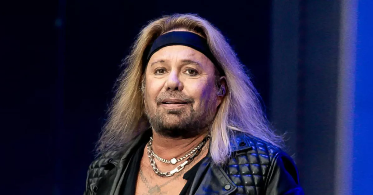 Vince Neil performing live on stage with signature blonde hair and leather jacket, showcasing the Mötley Crüe frontman's iconic rock star presence before his 2025 health challenges